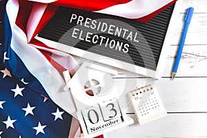 November 3 2020, 59th presidential election in USA. Flat lay composition : United states flag and calendar on white wood