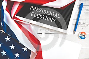 November 3 2020, 59th presidential election in USA. Flat lay composition : United states flag on white wood background . Vote by