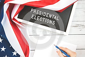 November 3 2020, 59th presidential election in USA. Flat lay composition : United states flag on white wood background . Vote by