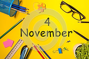 November 4th. Day 4 of last autumn month, calendar on yellow background with office supplies. Business theme