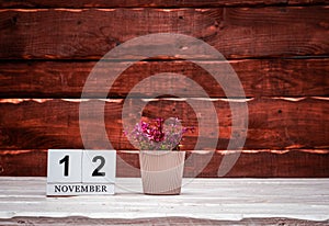 November calendar with number 12. Planner copy space on a wooden brown background. March number icon. Place for text background