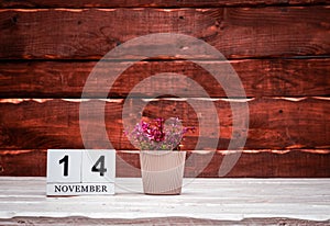 November calendar with number 14. Planner copy space on a wooden brown background. March number icon. Place for text background