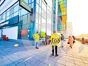 November 2, 2021, St. Petersburg, Russia, Walking couriers with yellow backpacks await orders from McDonald`s