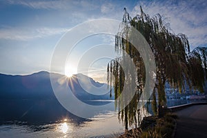 November sunrise on Lugano Lake, with reflections on water