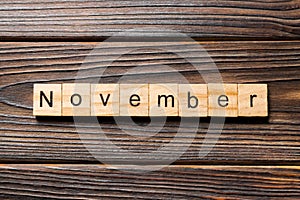 November word written on wood block. November text on wooden table for your desing, Top view concept