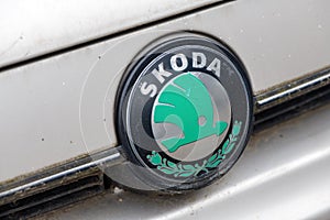 Old Skoda logo on worn white vehicle. Czech automobile manufacturer is now part of Volkswagen