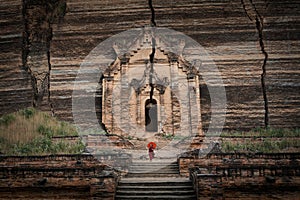 Novice Buddhist Monk at the Ruins of the Mingun Pahtodawgyi Pagoda in Sagaing, Mandalay, Myanmar Burma