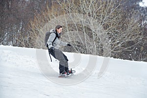 Novice girl is learning to ski with snowboard