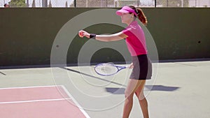 Novice tennis player doing an underhand serve