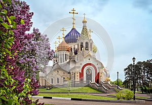 Novo-Peredelkino Church with lilac, Moscow, Russia photo