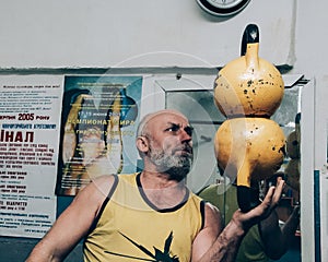 Senior man working out using kettlebell