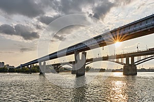 Novosibirsk Metro Bridge over Ob River in Novosibirsk, Russia. Cityscape on sunset