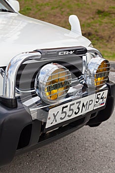 Novosibirsk, Russia - 07.07.20: Front view of a Honda CR-V car in a white body of a Japanese crossover with piaa fog lights and a