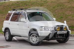 Novosibirsk, Russia - 07.07.20: Front view of a Honda CR-V car in a white body Japanese two thousandth crossover in a parking lot