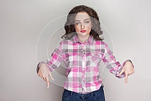 Now and here. serious beautiful girl with pink checkered shirt,