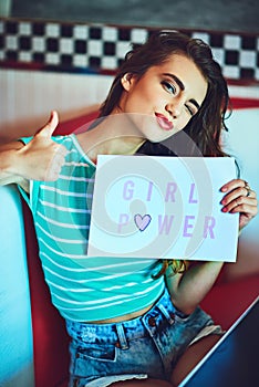 Now heres a message that I can get behind. Cropped portrait of an attractive young woman holding up a sign in a retro
