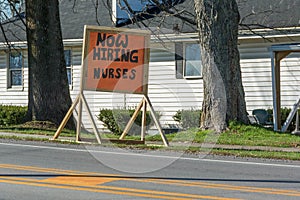 Now hiring nurses nurse sign in front of a local nursing home