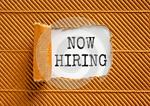 Now hiring symbol. Concept words Now hiring on beautiful white paper. Beautiful brown paper background. Business marketing,