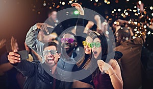 Now this is how you party. Cropped shot of a diverse group of young friends taking a selfie together at a party at night