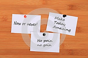 `Now or never!` `Make Today Amazing`. `No pain no gain.` Note pin on the bulletin board.