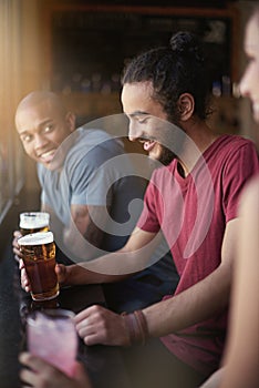 Now thats a fine pint. a group of friends enjoying themselves in the pub.