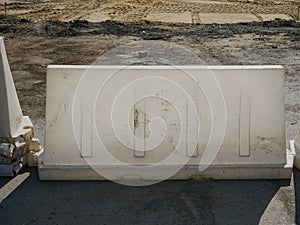 Noyabrsk, Russia - August 9, 2020: A white plastic road block stands on a concrete road to restrict traffic and road works