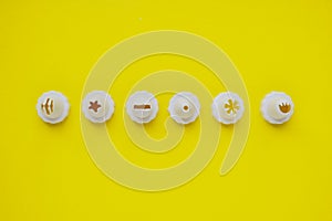 Nozzles for a confectionery syringe on a yellow background