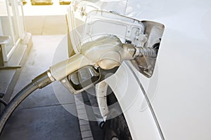 Nozzles in the gas station. A diesel dispenser that is filling up with a car that stops for fuel during the trip