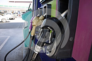 Nozzles in the gas station. A diesel dispenser that is filling up with a car that stops for fuel during the trip