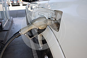 Nozzles in the gas station. A diesel dispenser that is filling up with a car that stops for fuel during the trip