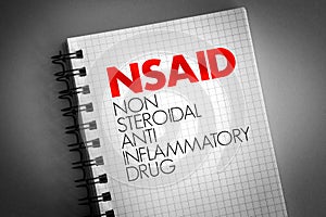 NSAID - nonsteroidal anti-inflammatory drug acronym on notepad, concept background