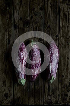 Nubia eggplants over a wooden table.