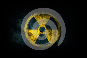 Nuclear energy radioactive ionizing atomic radiation round yellow symbol shape painted on massive concrete cement wall texture