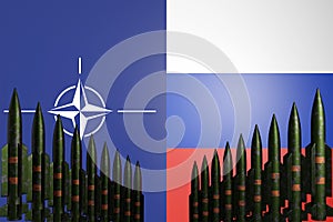 Nuclear missiles standing in row with NATO and Russia flags on background. Cold war concept. Russian-ukrainian conflict