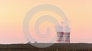 Nuclear power plant cooling towers at sunset.