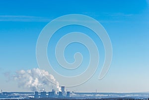 Nuclear power plant on the sky background. Cooling towers of NPP with smoke.