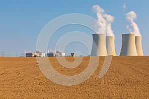 Nuclear power plant Temelin in Czech Republic Europe with plowed field.