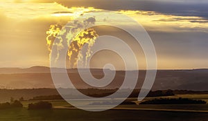 Nuclear power plant vapor illuminated by the setting sun