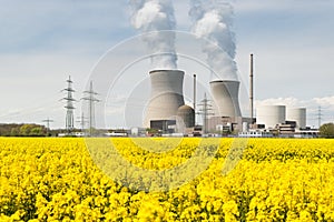 Nuclear power plant with yellow field and big blue clouds in Ger