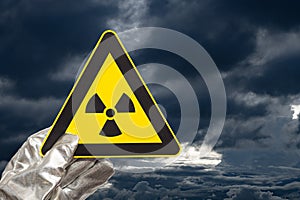 a nuclear radiation warning sign with dark and heavy clouds