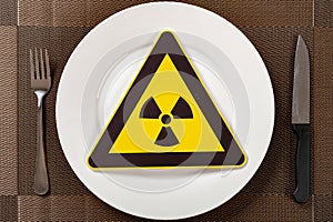 a nuclear radiation warning sign on a dish concept of unsafe food