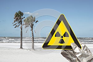 a nuclear radiation warning sign in front of a beach