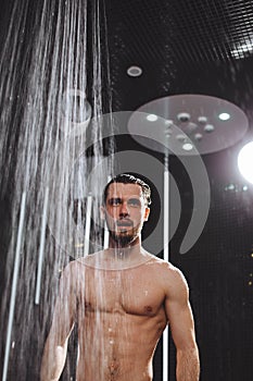 Nude brutal guy is going to take a shower . cool down in shower.cool head