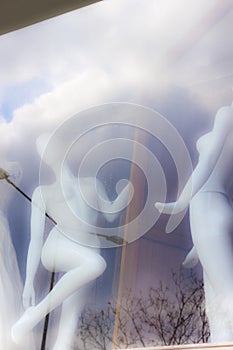 Nude female manequines at shopping window