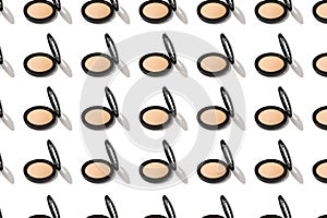 Nude powder in a round compact case on a white background isolated. A pattern of beauty cosmetic makeup with a beige foundation.