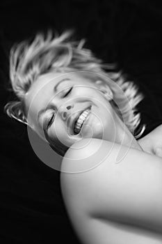 Nude woman smiling.