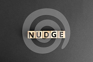 Nudge - word from wooden blocks with letters