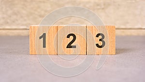 number 1, 2 and 3 on cubes, gray background, selective focus