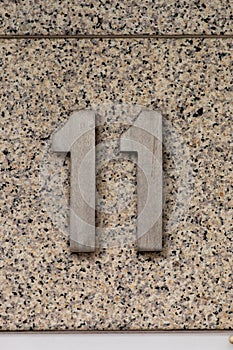 Number 11 house number on stone wall