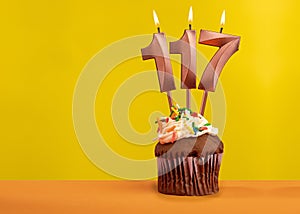 Number 117 birthday candle - Celebration on yellow background